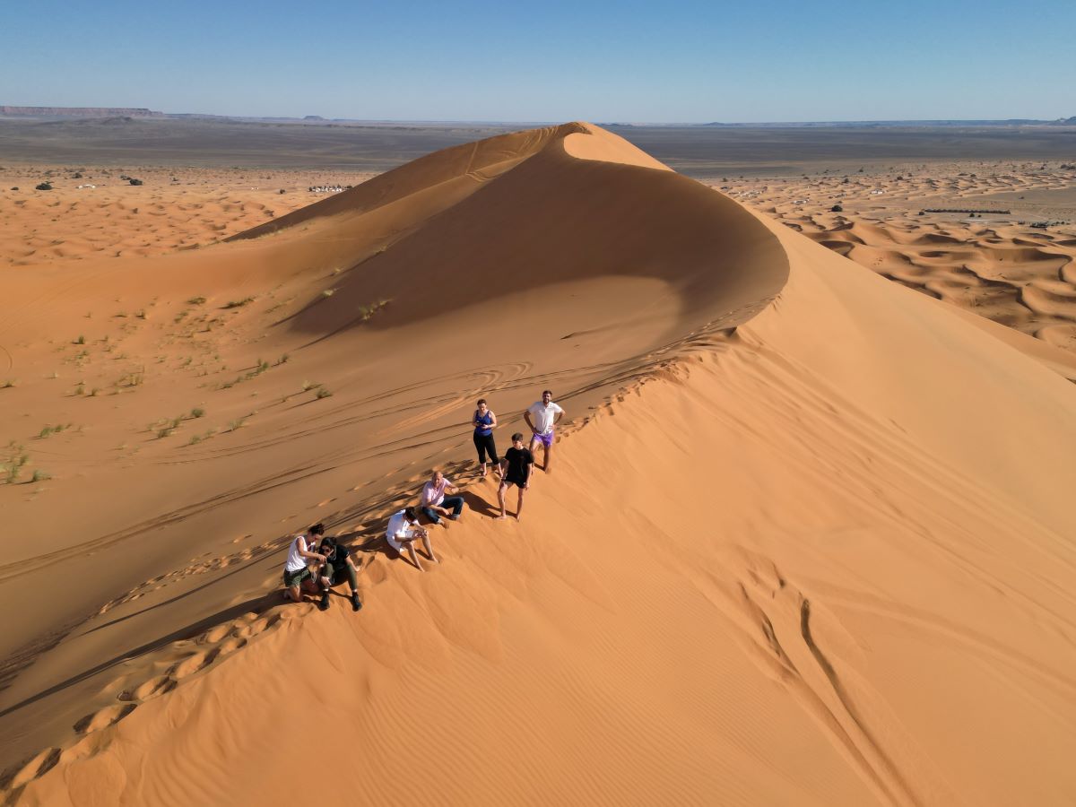 Team picture in front of off road vehicle